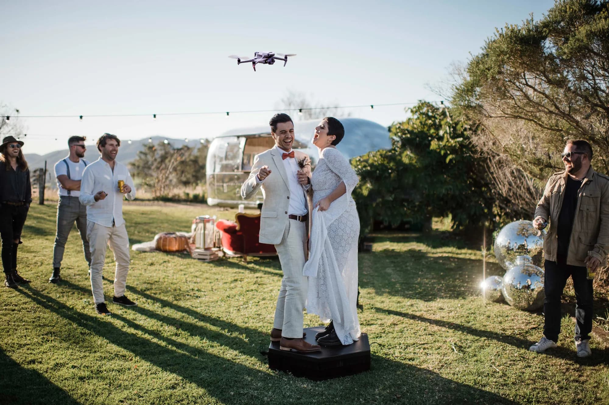 Guest on a 360 photo booth platform with LED lighting and red carpet in Orlando