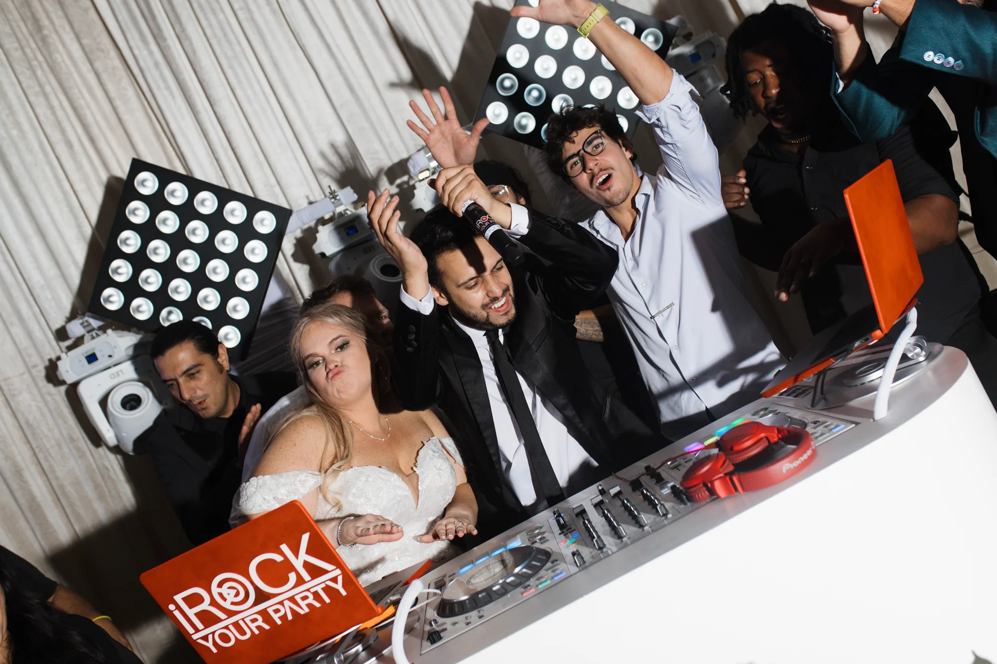 iRock Your Party DJ behind the booth as the bride, groom and guests celebrate on the dance floor at an Orlando wedding