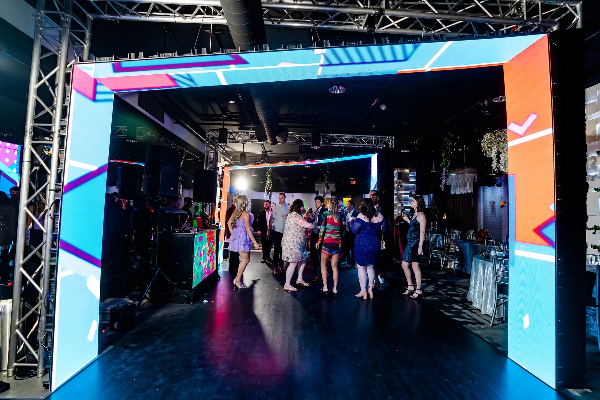 Guests walking through an illuminated projection and LED tunnel at an Orlando event by iRock Your Party