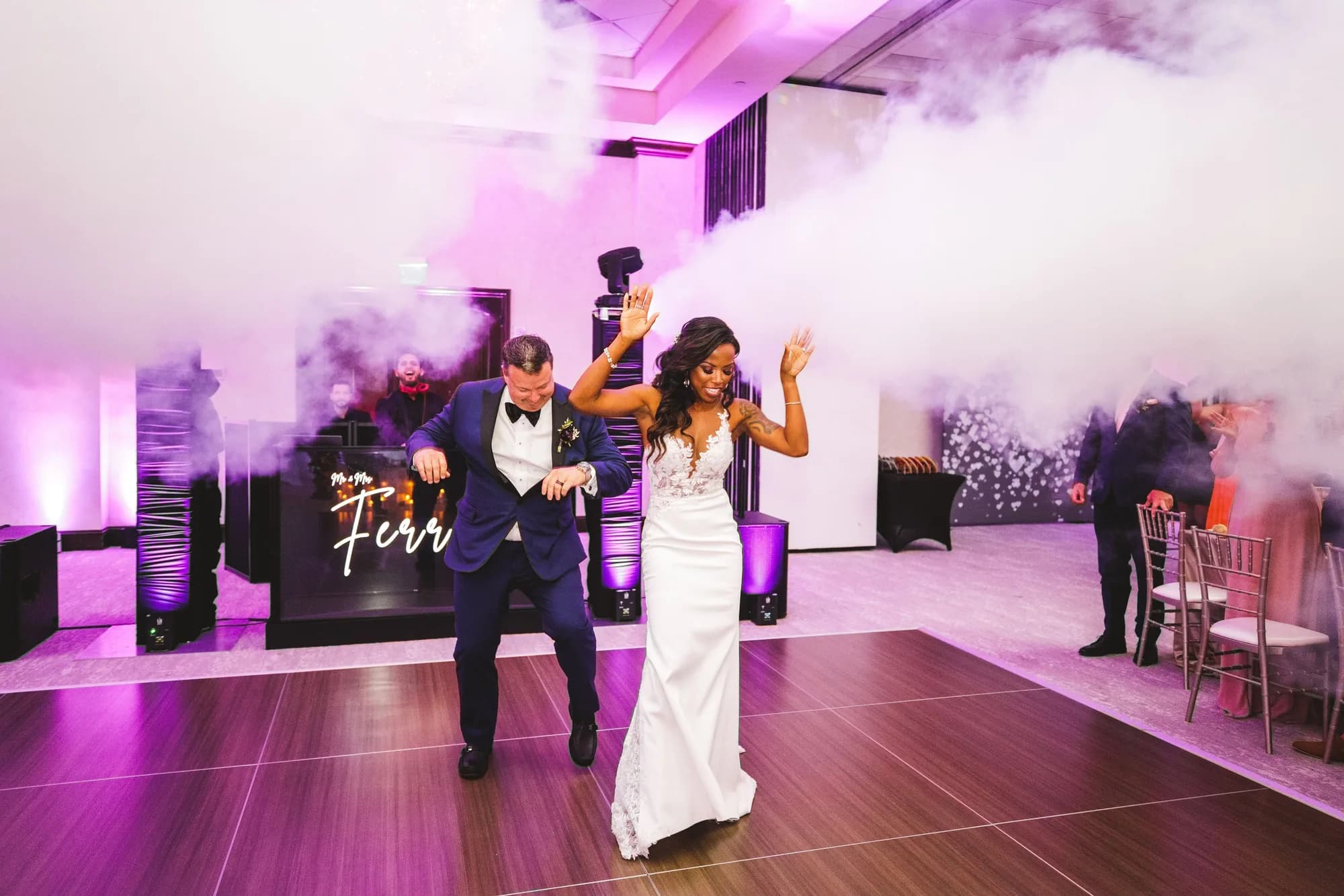 iRock Your Party DJ behind the booth with the bride, groom and guests dancing at an Orlando wedding